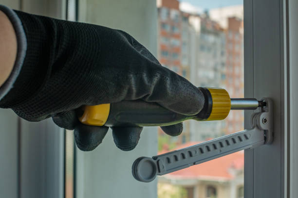 istock The master installs a window opening limiter on a plastic window frame. Close-up of a hand with a screwdriver twisting the fixing screws of the window frame fittings. Improvement at home 1500001544