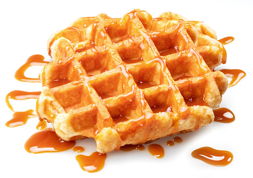 True Belgian waffle with extra deep pockets and caramel topping isolated on white background.