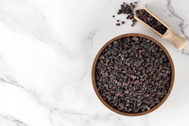istock Himalayan crystal black salt in a gray bowl on a white background. Spices background. 1500005766