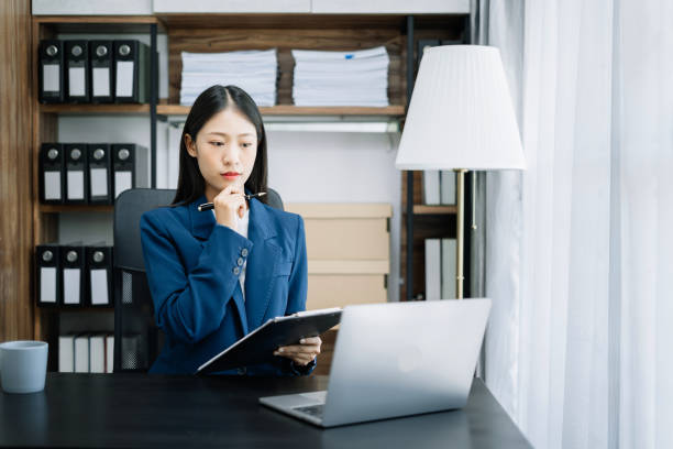 istock businesswoman thinking work concept sitting at desk in the office. 1500007168