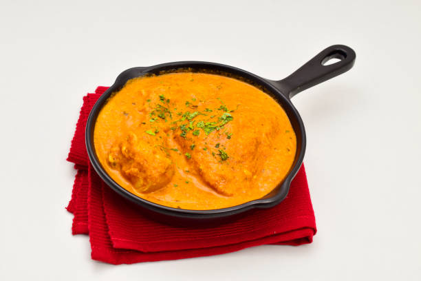 Butter chicken plate on white background, murg makhani