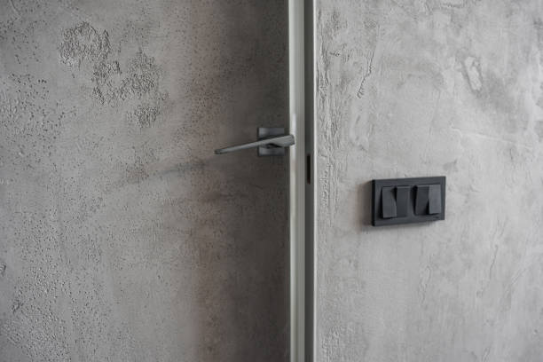 istock doorknob and black light switch keys on a gray wall. 1500009884