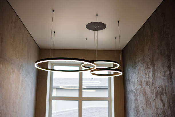 istock Modern ceiling lamp of three rings in the interior. 1500010273