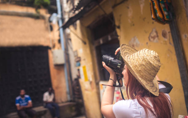 istock happy young female traveller taking photo with camera 1500010389