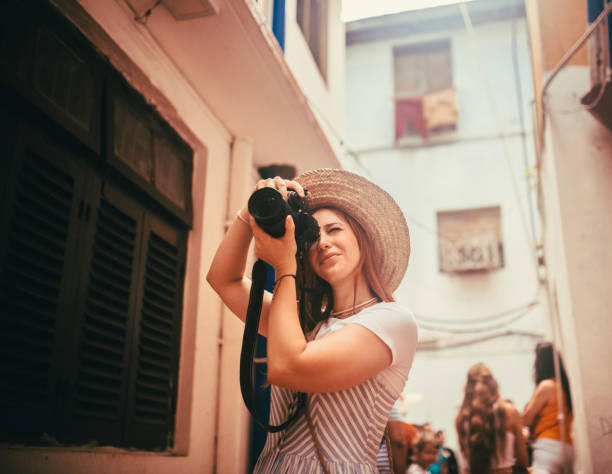 istock happy young female traveller taking photo with camera 1500010417