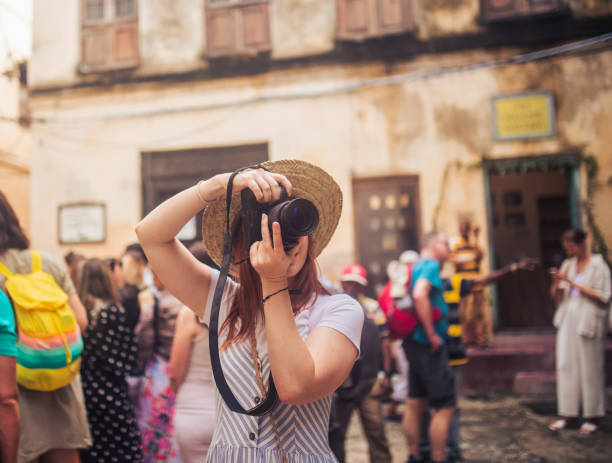 istock happy young female traveller taking photo with camera 1500010711
