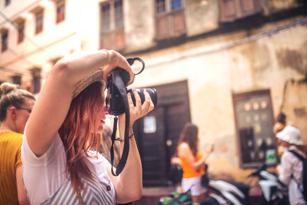 istock happy young female traveller taking photo with camera 1500010803