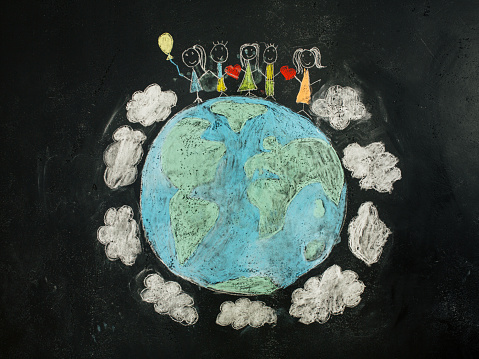 Chalk drawing of Planet Earth in colors with group of children holding hands concept of unity, love and peace in the world unity, peace,