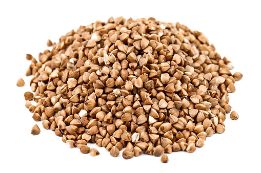 Heap of buckwheat grains isolated on white background