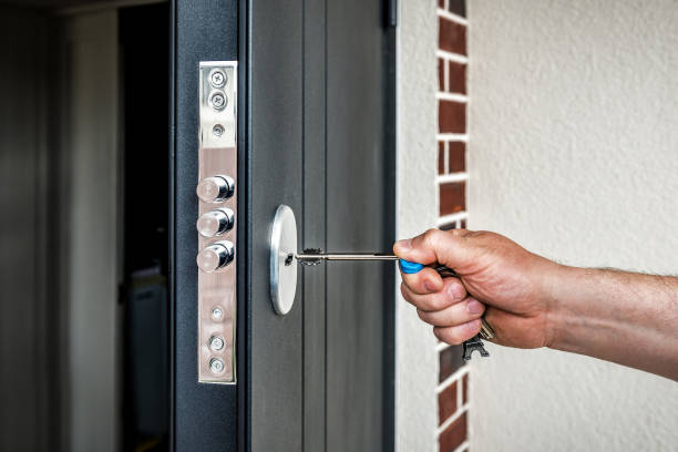 Human hand puts the key in the keyhole stock photo