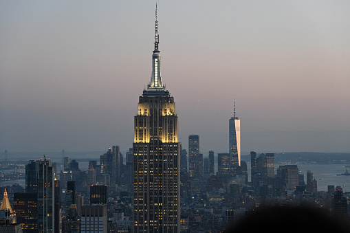 New York, USA, April 13, 2023 - Empire State Building at night, Manhattan skyline in the background, New York.