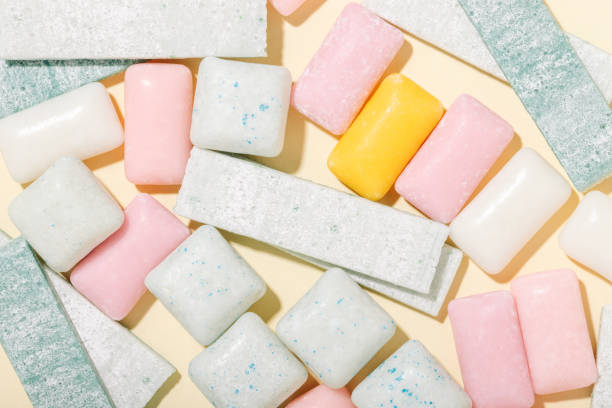 istock Various types of mint and fruit gum on a yellow background top view 1500014047
