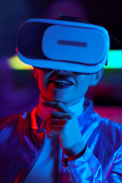 istock happy business woman in virtual reality goggles on dark 1500016749