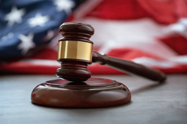 Close up of wooden judge gavel over the american flag - fotografia de stock