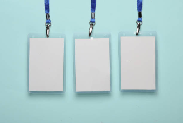 istock Empty white ID card badges mockup with blue belt, on blue background. Staff identity name tag. Space for your text. Top view. Flat lay 1500021578