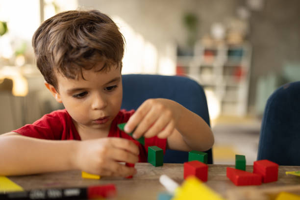istock Little boy playing with toy blocks 1500022298