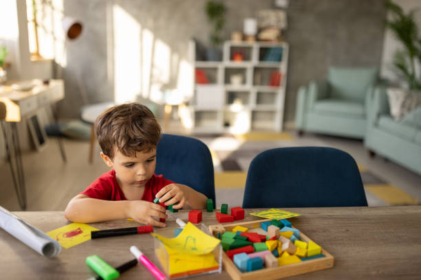 istock Little boy playing with toy blocks 1500022319