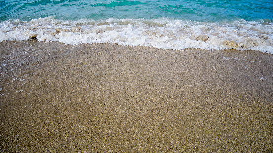 Soft blue ocean wave on clean sandy beach. Bangka Island, Indonesia.