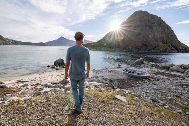 istock Man walks on the coastline and admires nature 1500024745