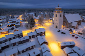 Illuminated village of Gammelstad at dusk, aerial view