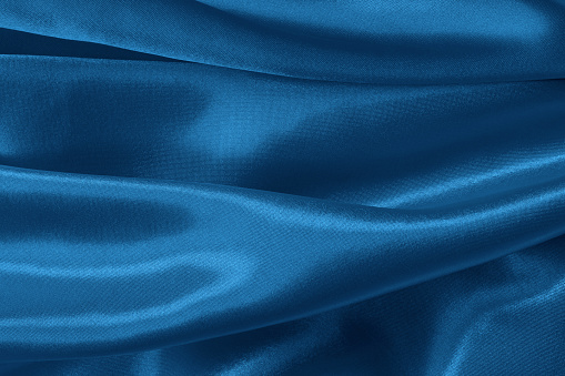 Blue fabric cloth texture for background and design art work, beautiful crumpled pattern of silk or linen.