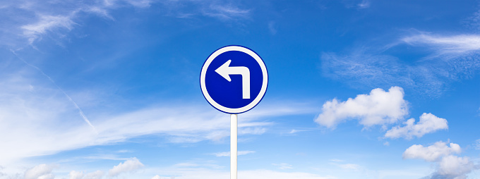 Panoramic blue sky with fluffy clouds and road sign