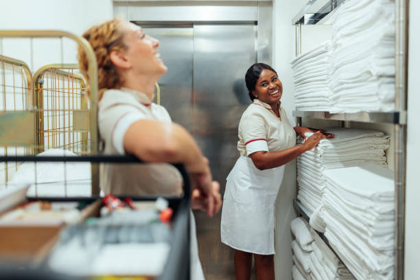 istock Interracial hotel maids having fun conversation in laundry 1500033268