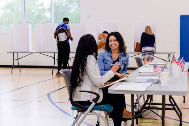 istock Female volunteers enjoy conversation while they take a break from greeting voters 1500037435