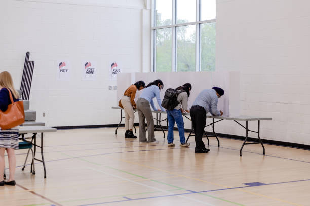 istock Voters stand at their voting booths to make their selections 1500037453