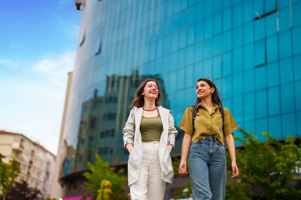 Two young women walking in downtown stock photo