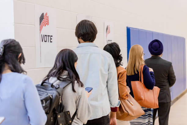istock Unrecognizeable voters stand in line as they wait to cast their ballots 1500037497