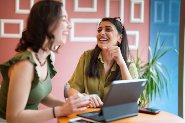 istock Young female adults meets at coffee shop, using digital tablet 1500039672