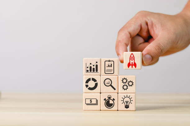 istock Hand holding a wooden block with a rocket icon 1500041233