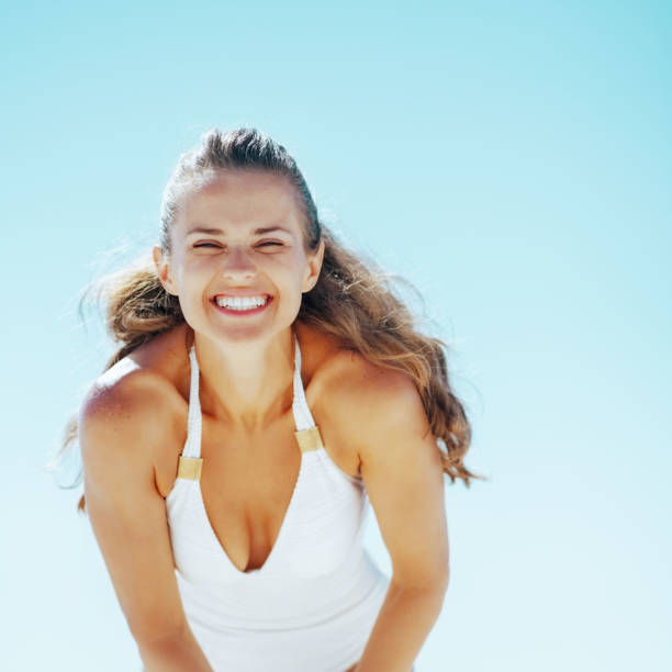 istock smiling young woman on beach 1500041684