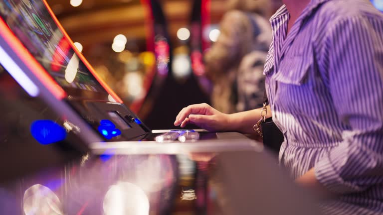 hand close up Exited Young Asian cheerful woman enjoy playing on a slot machine at the casino and winning, celebrate woman win slot machine