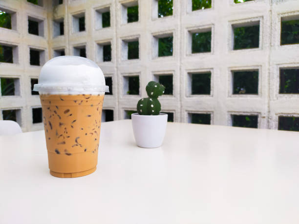 The Thai tea on the table is a delightful and refreshing beverage that captures the unique flavors of Thailand. Its vibrant orange color and creamy texture make it an irresistible treat. on Thai tea .