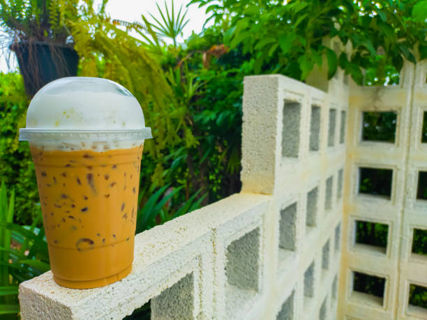 The Thai tea on the table is a delightful and refreshing beverage that captures the unique flavors of Thailand. Its vibrant orange color and creamy texture make it an irresistible treat. on Thai tea .
