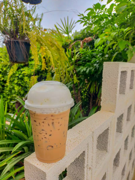 The Thai tea on the table is a delightful and refreshing beverage that captures the unique flavors of Thailand. Its vibrant orange color and creamy texture make it an irresistible treat. on Thai tea .