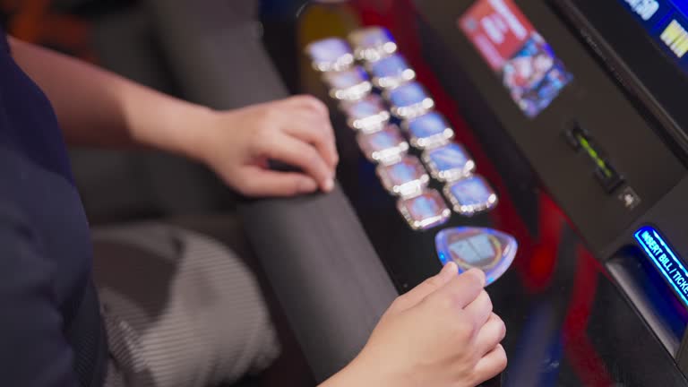 hand close up Exited Young Asian cheerful woman enjoy playing on a slot machine at the casino and winning, celebrate woman win slot machine