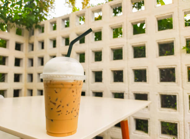 The Thai tea on the table is a delightful and refreshing beverage that captures the unique flavors of Thailand. Its vibrant orange color and creamy texture make it an irresistible treat. on Thai tea .