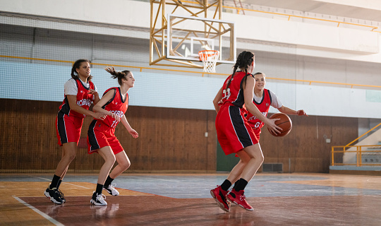 Group of female basketball players playing basketball