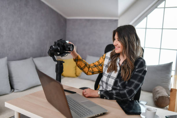 istock Smiling Female Setting Up Camera T o Record Vlog 1500049918