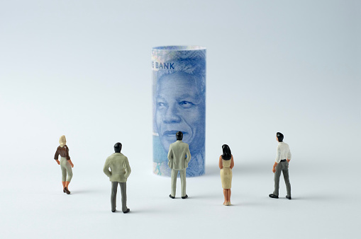 Businessman/Politician figurines scrutinize the South African rand (Economy of South Africa)