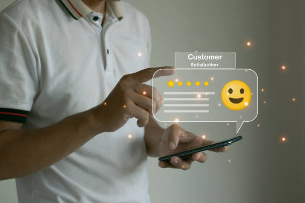 istock Man using a smartphone to rate service satisfaction through a figurative app 1500052281