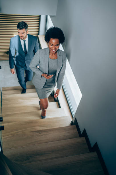 istock Business persons going up the stairs in the office. 1500054571