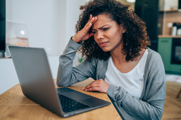 istock Stressed woman using laptop at home. 1500054598
