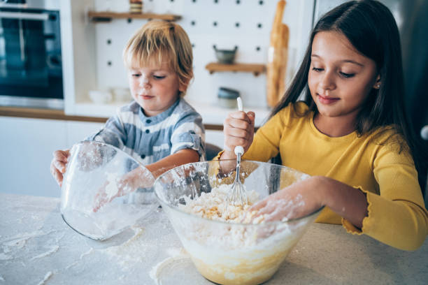 istock Brother and sister cooking together. 1500055231