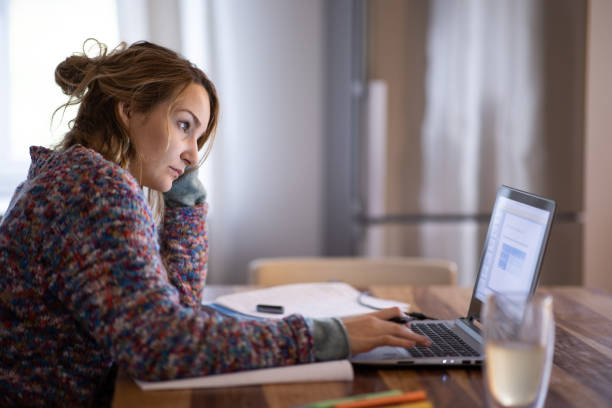 istock Young smiling pretty woman student using laptop 1500056560