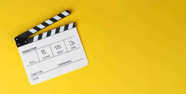 istock Clapper board or movie slate on yellow background. 1500060645