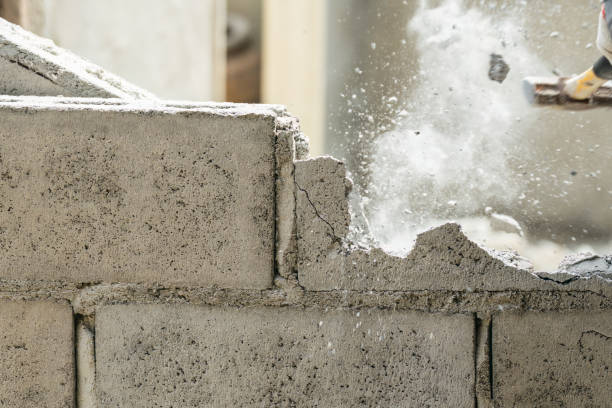 istock Hand of worker using hammer smashing and demolish on brick wall at construction site 1500060739